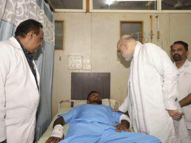 Viswashkumar Ramesh, the sole survivor of Thursday's Air India crash, meets with Home Affairs Minister Amit Shah at a hospital in Ahmedabad.