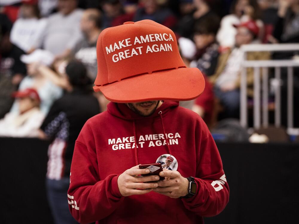 A supporter of President Trump wears an oversize 