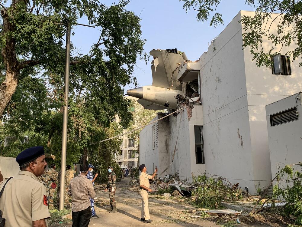 The back of Air India Flight 171 juts out of a building after the Boeing 787-8 Dreamliner crashed in a residential area near the airport in Ahmedabad on Thursday.