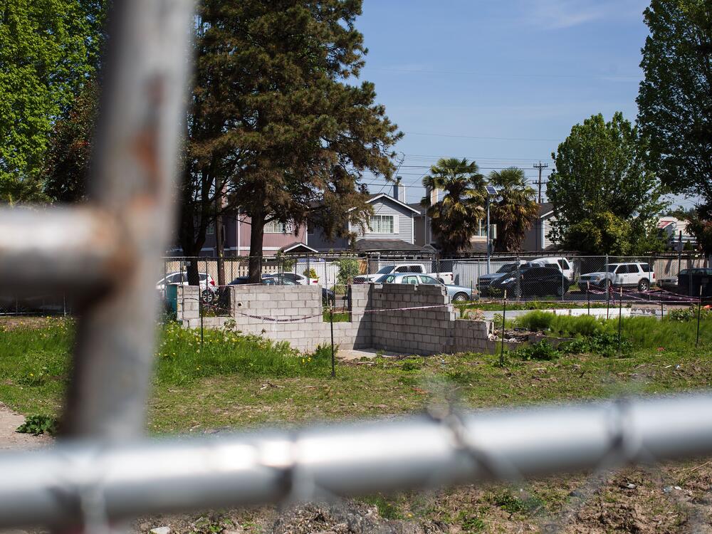 In Seattle's South Park neighborhood, residents have about half as much tree canopy as the citywide average. Four single-family homes once stood on this lot, where 22 new units will soon be built. Plans filed with the city show three large evergreens and several smaller trees that are still standing on the lot are slated for removal.