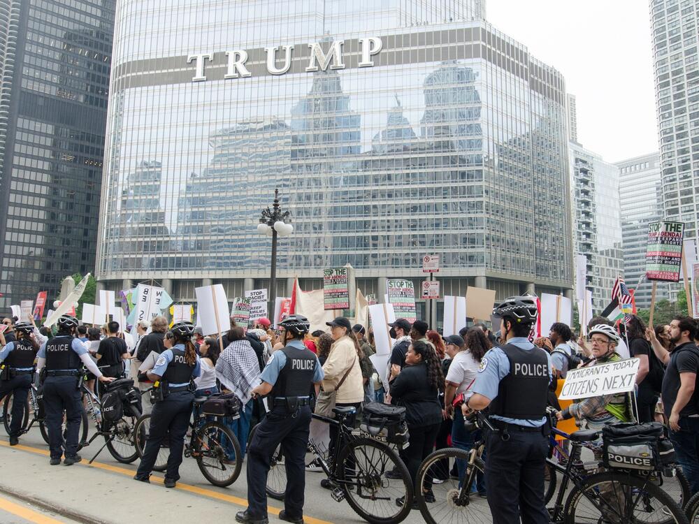 Protesters march through downtown Chicago on June 12, during the second day of demonstrations against Immigration and Customs Enforcement (ICE) raids and President Trump's immigration policies. Carrying signs reading 'Abolish ICE' and 'No More Deportations,' thousands rally in solidarity with immigrant communities, chanting for justice and an end to family separations.