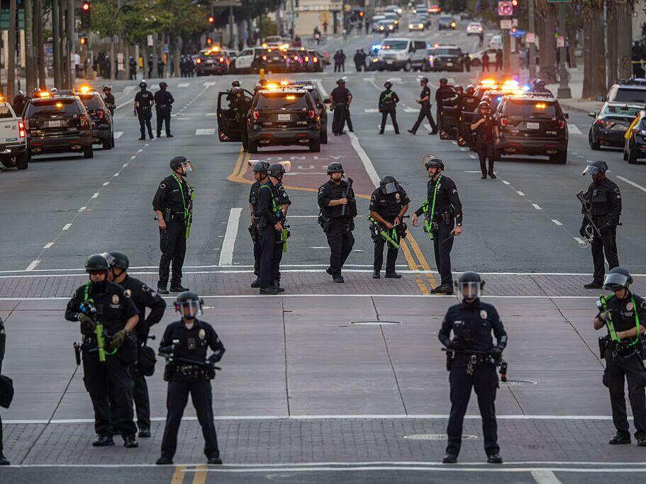 Police fill the streets when the 8:00 PM curfew commences as protests continue in an approximately one-square mile area of downtown Los Angeles in response to a series of immigration raids on June 12, 2025 in Los Angeles, California.