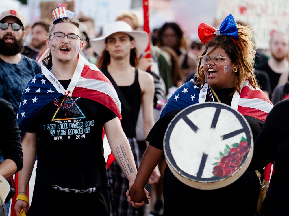 St. Louis: James Slinkard, 21, holds hands with Taylor Cunningham, 22, both of Cape Girardeau, Mo., while protesting. 