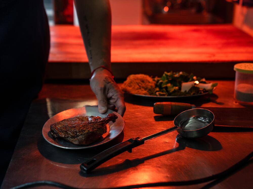 Chef Shuai Wang readies smoked duck for the fryer.  After shunning Chinese food in his youth, he's now embracing it.
