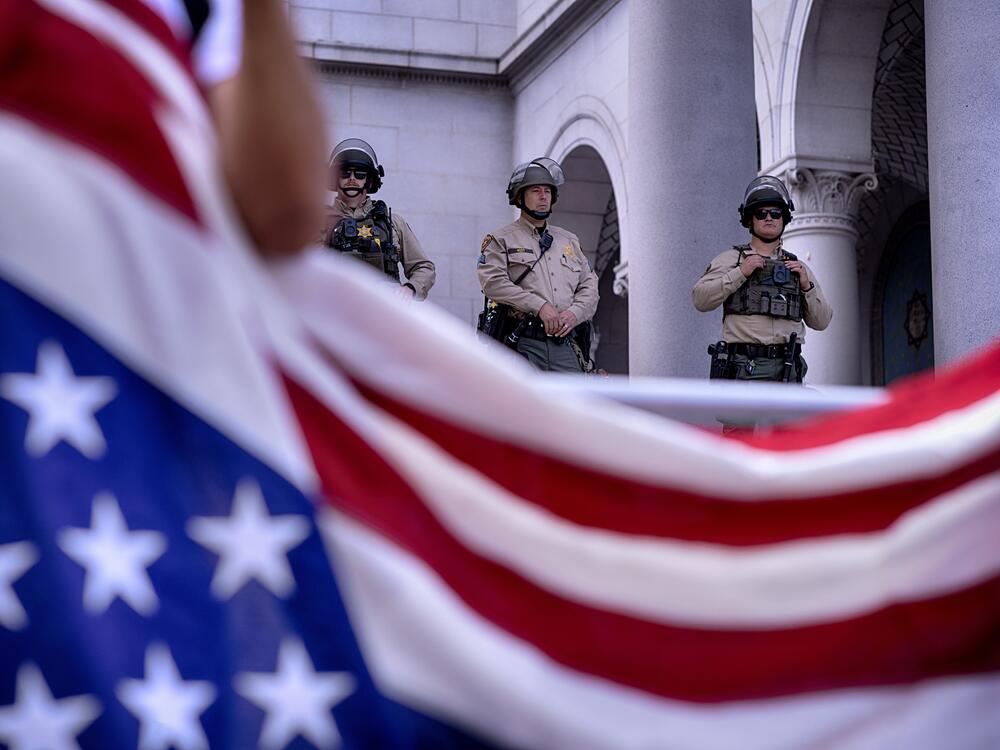 Los Angeles: Los Angeles Sheriff's deputies stand guard on the steps of Los Angeles City Hall as protesters assemble.