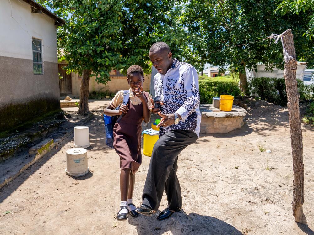 Pastor Billy and Diana share a close bond. When Pastor Billy visits Diana, she lights up with a smile. Here, they share a laugh before she walks to school.