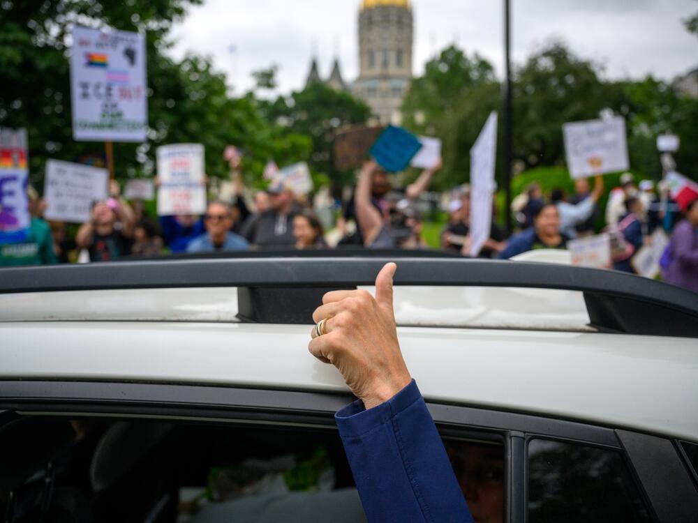 Hartford:  A passenger in a car gives a sign of support for protestors at the Connecticut State Capitol.