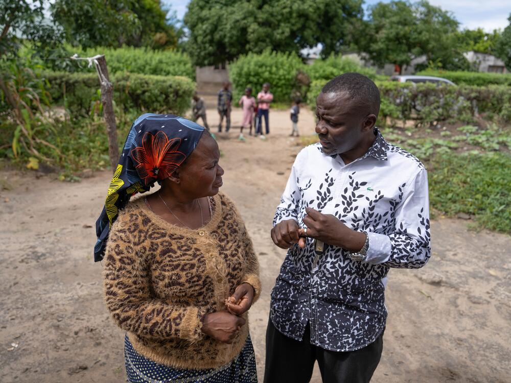 Pastor Billy talks with Jennifer Mukuka — who has taken in Diana — outside Mukuka's home in Kapiri Mposhi, Zambia.