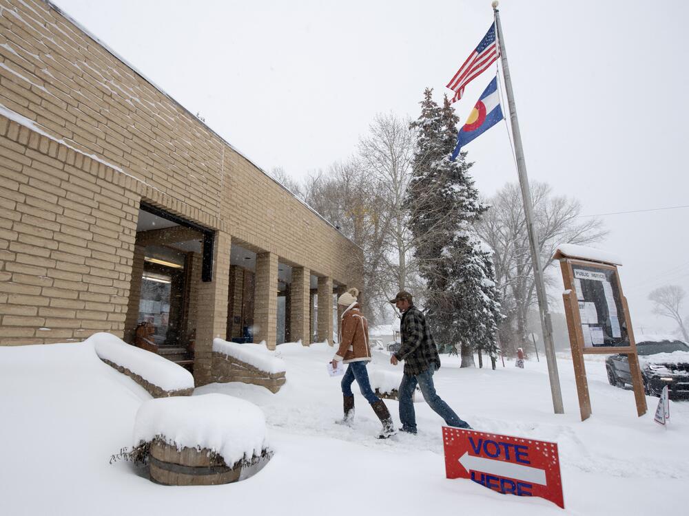 Voters walk into the Oak Creek Town Hall to drop off their ballots on Nov. 5, 2024, in Oak Creek, Colo.