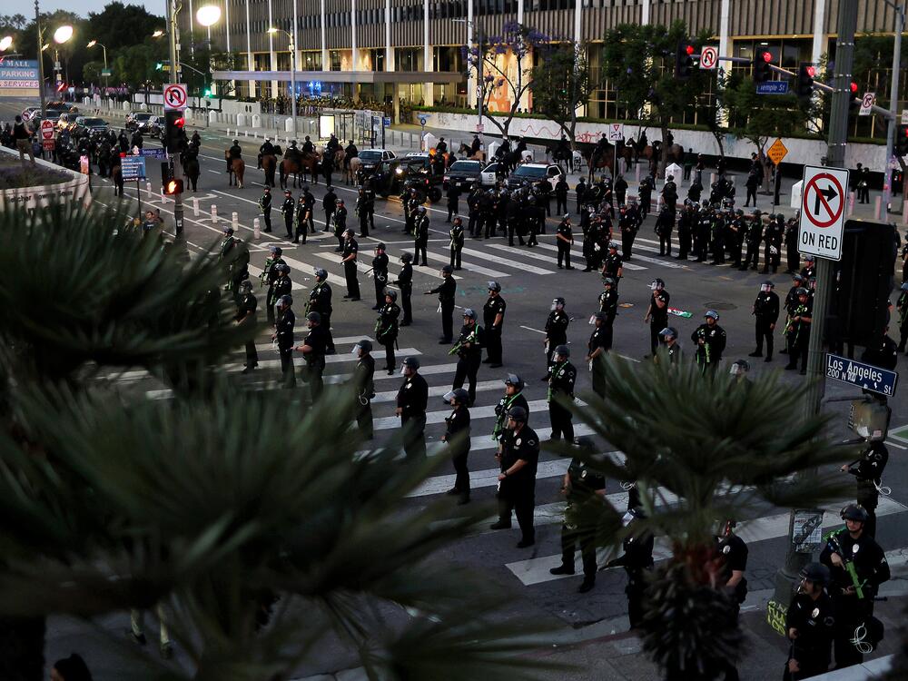 Police officers mobilize to enforce a curfew after it went into effect during a protest against ICE raids on June 10 in Los Angeles.