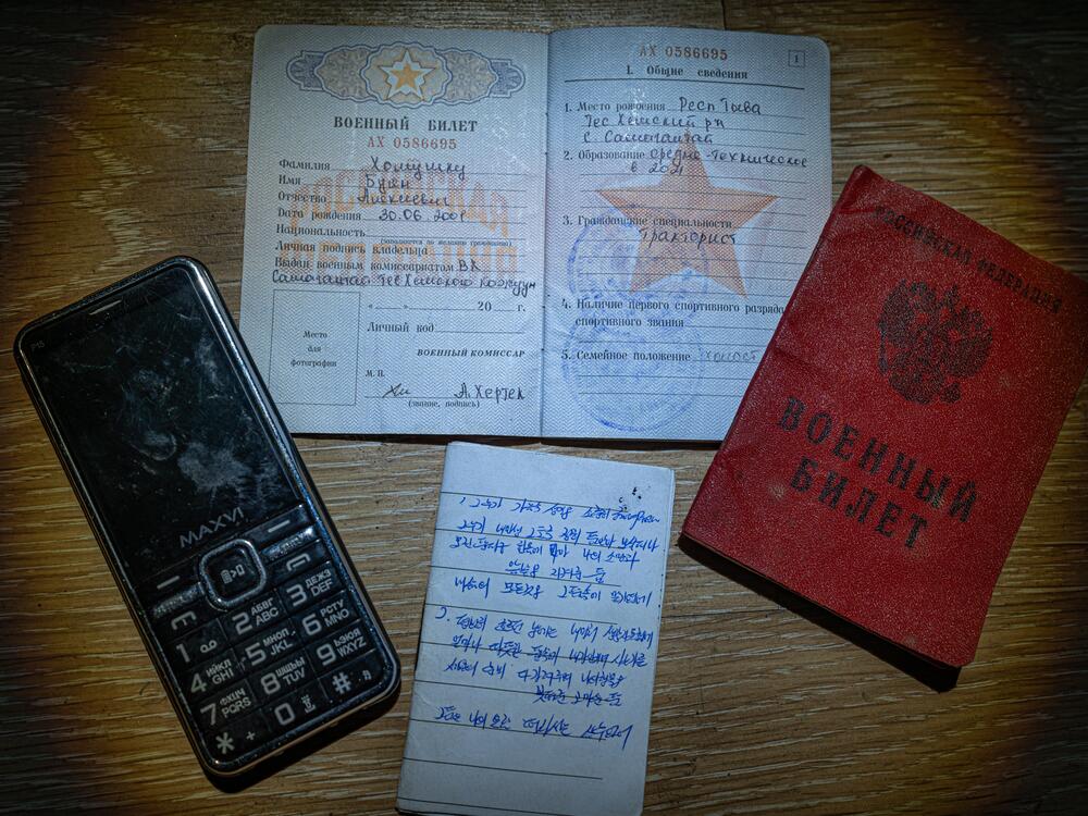 An old-model cellphone, Russian military IDs and a notebook page are among the belongings found by Ukraine's special forces on fallen North Korean soldiers fighting in Kursk.