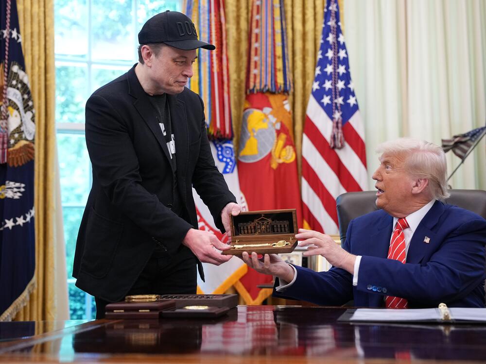 Elon Musk receives a key from President Trump in the Oval Office on May 30, 2025 to thank him for his work with the Department of Government Efficiency. Days later, the pair were feuding online, though Musk has since apologized.