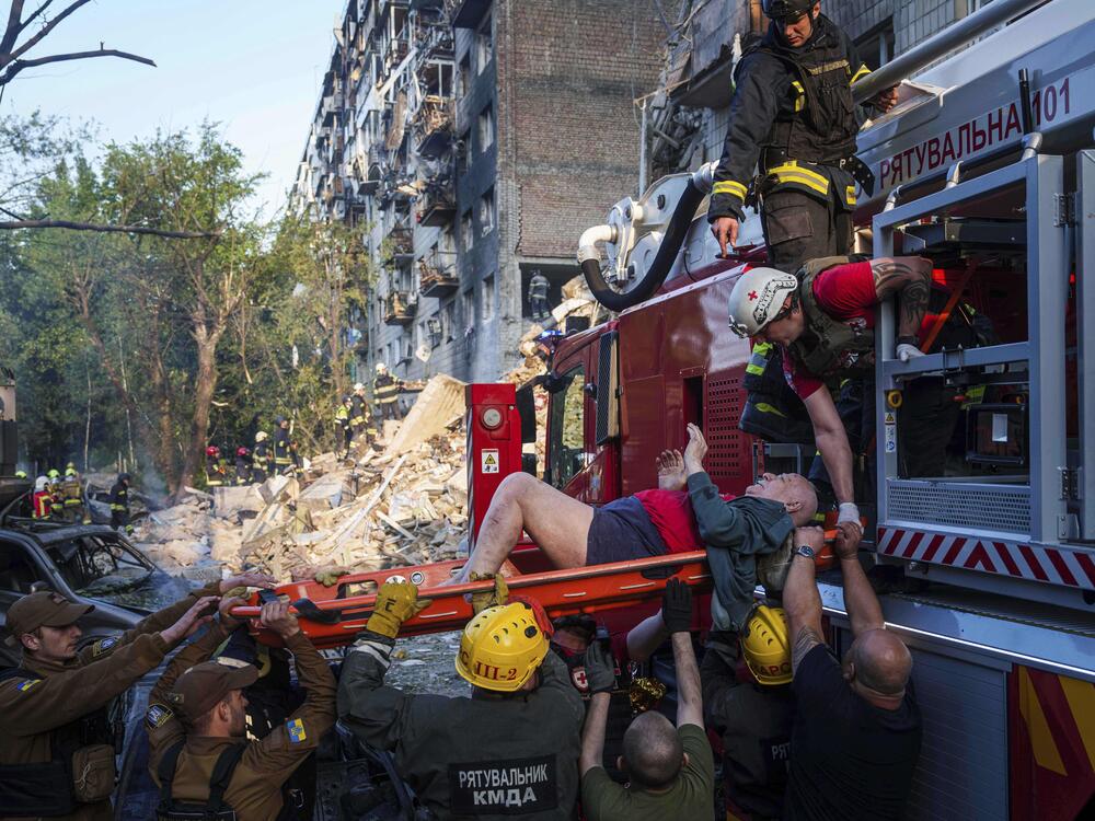 Rescue workers evacuate an injured man from a multi-story residential house destroyed by a Russian strike in Kyiv, Ukraine, on Tuesday.