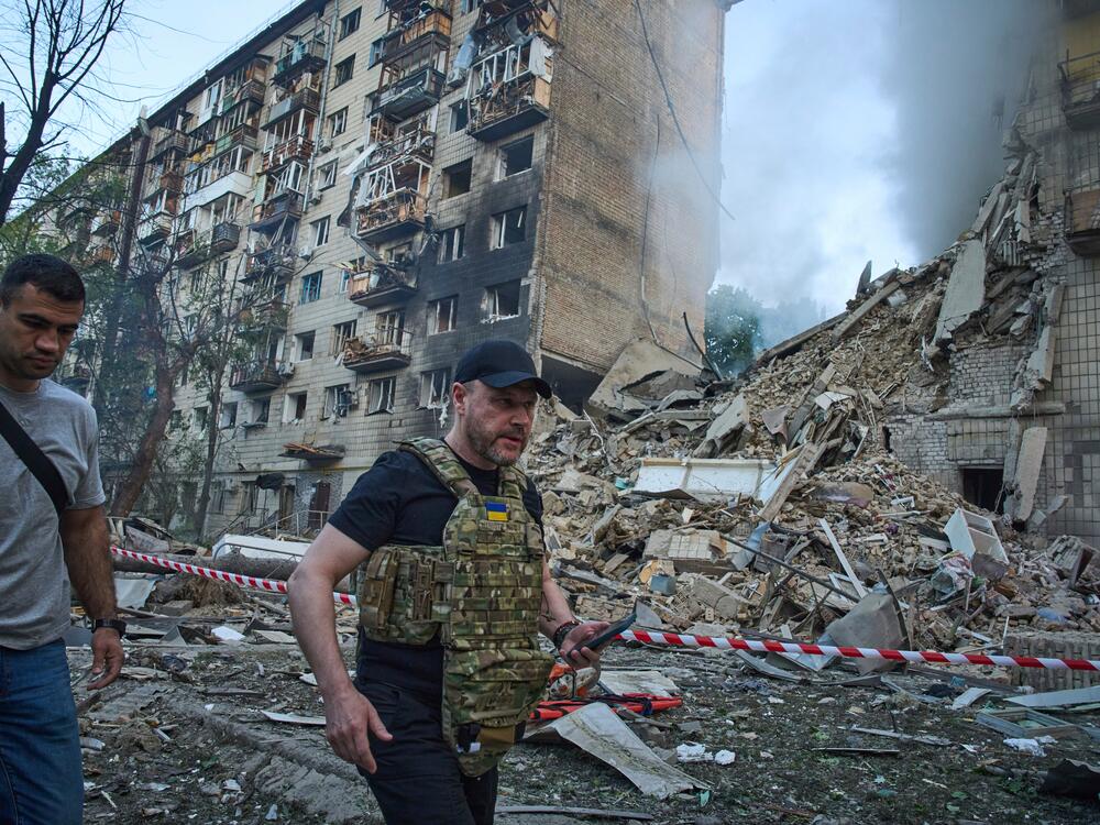 Ukraine Interior Minister Ihor Klymenko, right, examines the site of a missile strike that ruined a residential building during Russia's massive missile and drone air attack in Kyiv, Ukraine, on Tuesday.