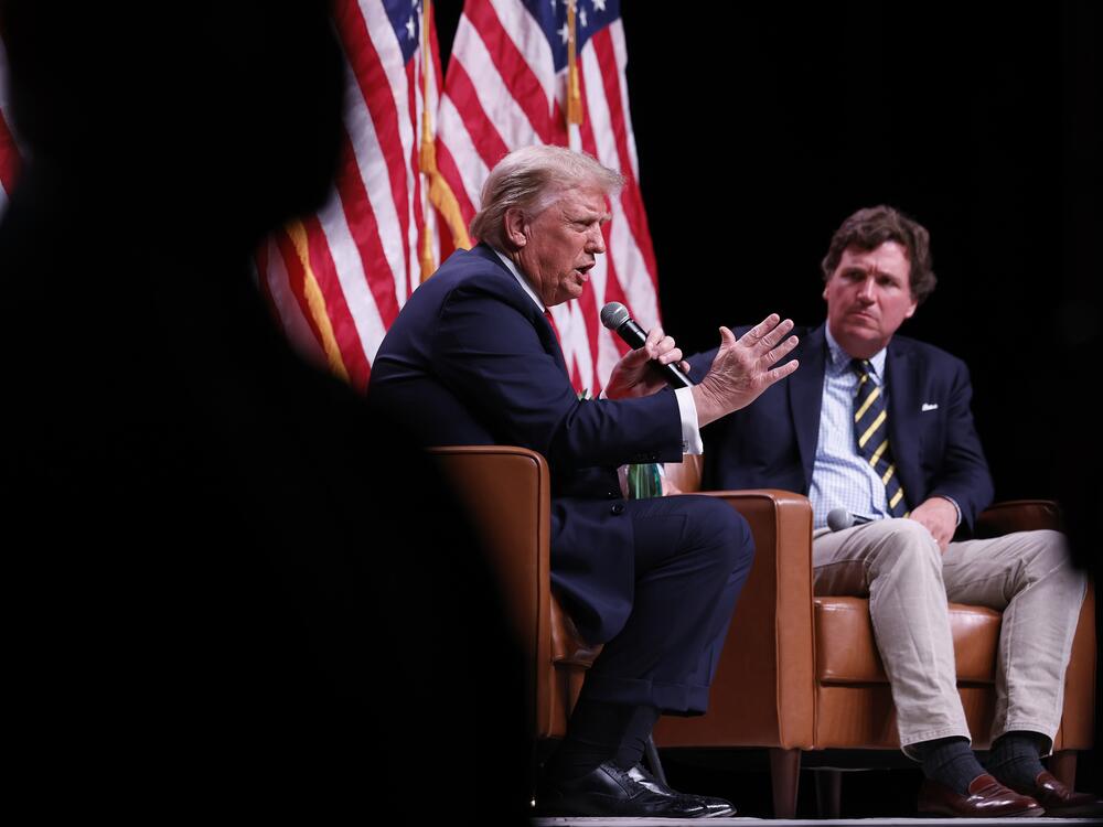 President Trump and Tucker Carlson speak during a campaign event in Phoenix, Arizona, on Oct. 31, 2024.