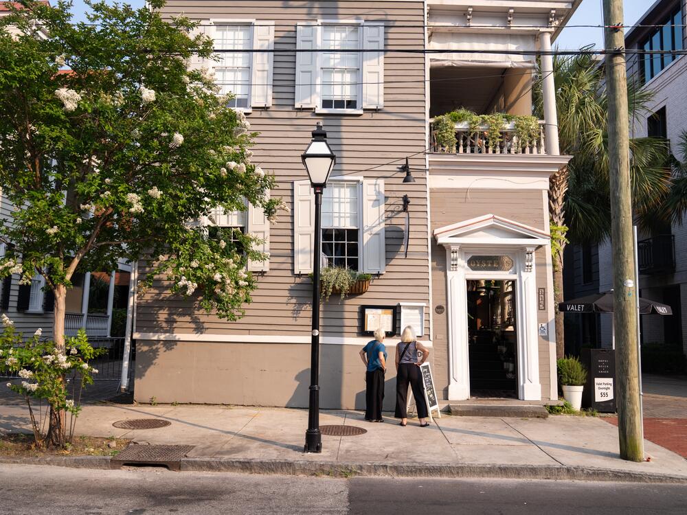 People look at the menu of a restaurant across the street from Mother Emanuel African Methodist Episcopal Church in Charleston, S.C.