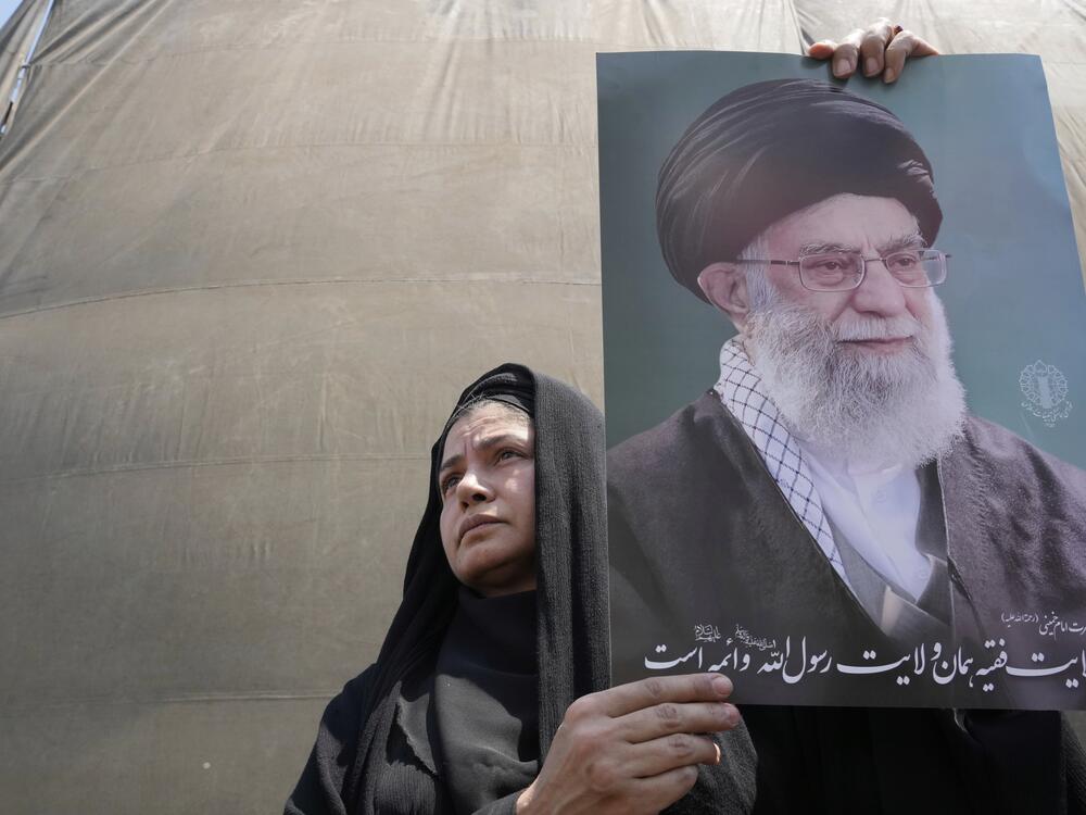 An Iranian protester holds up a poster of the Supreme Leader Ayatollah Ali Khamenei in an anti-Israeli gathering in Tehran, Iran, Friday, June 13, 2025.