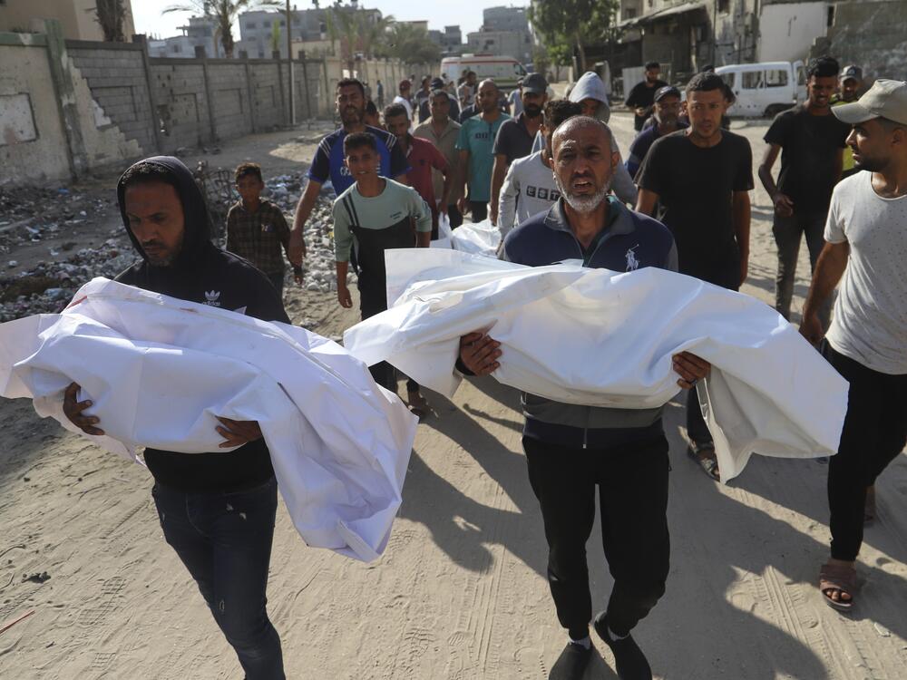 Palestinians carry the bodies of relatives killed in an Israeli strike, at Nasser Hospital in Khan Younis on Tuesday.