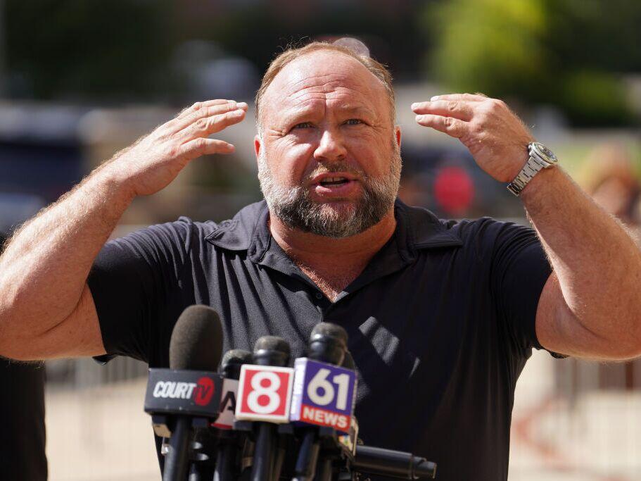 InfoWars founder Alex Jones speaks to the media outside Waterbury Superior Court during his trial on September 21, 2022 in Waterbury, Connecticut in which he was being sued by several victims' families for causing emotional and psychological harm after they lost their children in the Sandy Hook massacre.