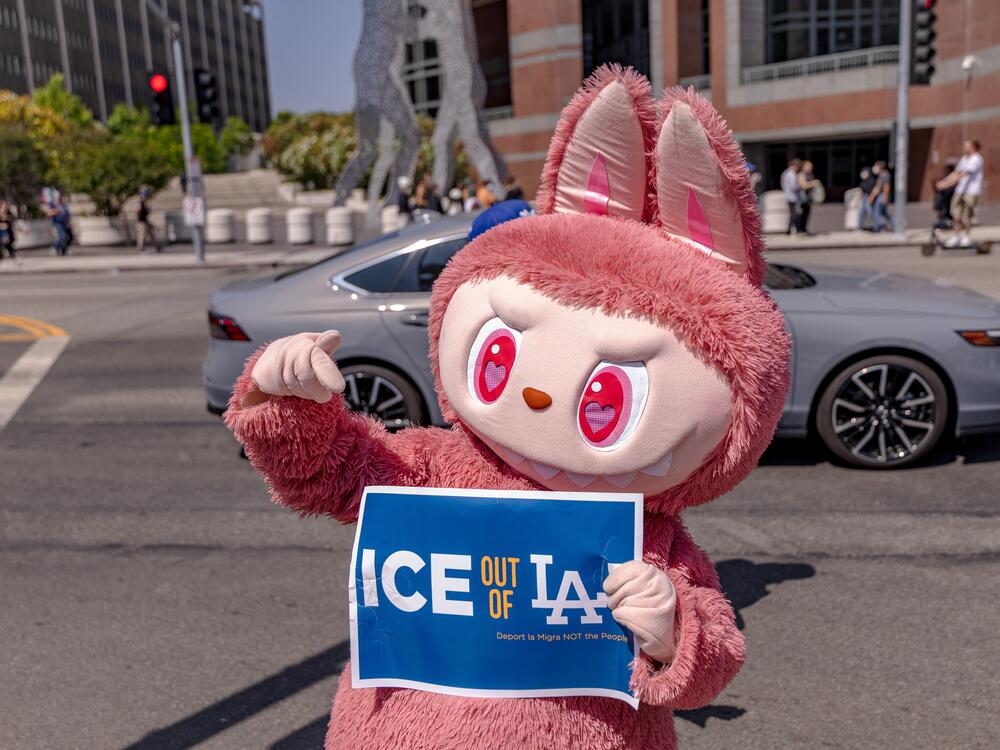 A protester wearing a Labubu costume holds a placard calling on ICE to leave LA as protesters continue anti-ICE demonstrations on the second day in Los Angeles on June 7.