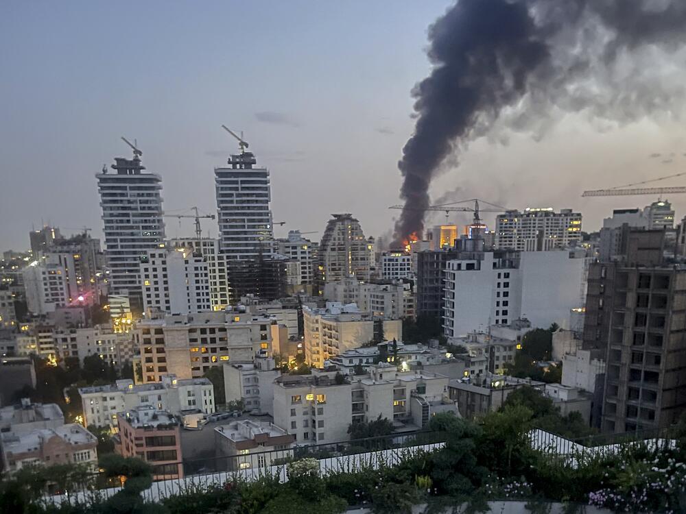 Smoke rises from the rubble of an Iranian state media building in Tehran after an Israeli airstrike on June 16, 2025. The strike, which Israel confirmed targeted 