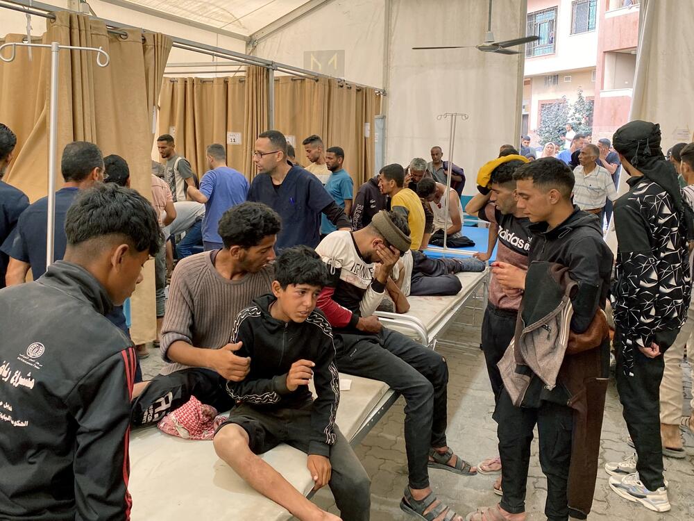 Palestinians injured in Israeli fire as they gathered near a food aid center receive care at Khan Younis' Nasser hospital in the southern Gaza Strip on Tuesday.