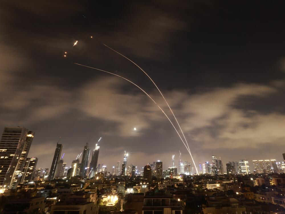 Israeli air defense systems fire to intercept Iranian missiles over Tel Aviv before dawn Wednesday. Israel and Iran exchanged fire for a sixth day.