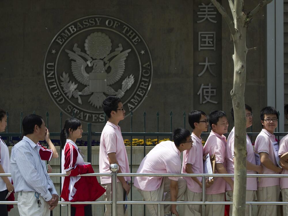 Chinese students wait outside the U.S. Embassy for their visa application interviews, in Beijing on May 2, 2012.
