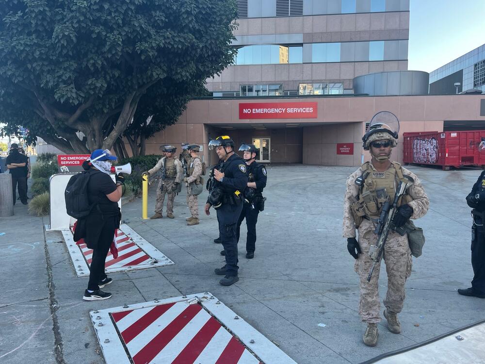 Anti-ICE protesters face off with Homeland Security officers and Marines outside the federal building in downtown Los Angeles on Monday evening