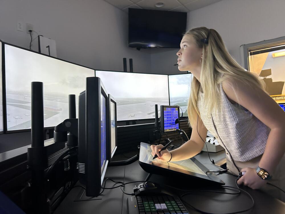 Hailee Williamson stands behind the controls of an air traffic control simulator at Embry-Riddle Aeronautical University in Daytona Beach, Fla.