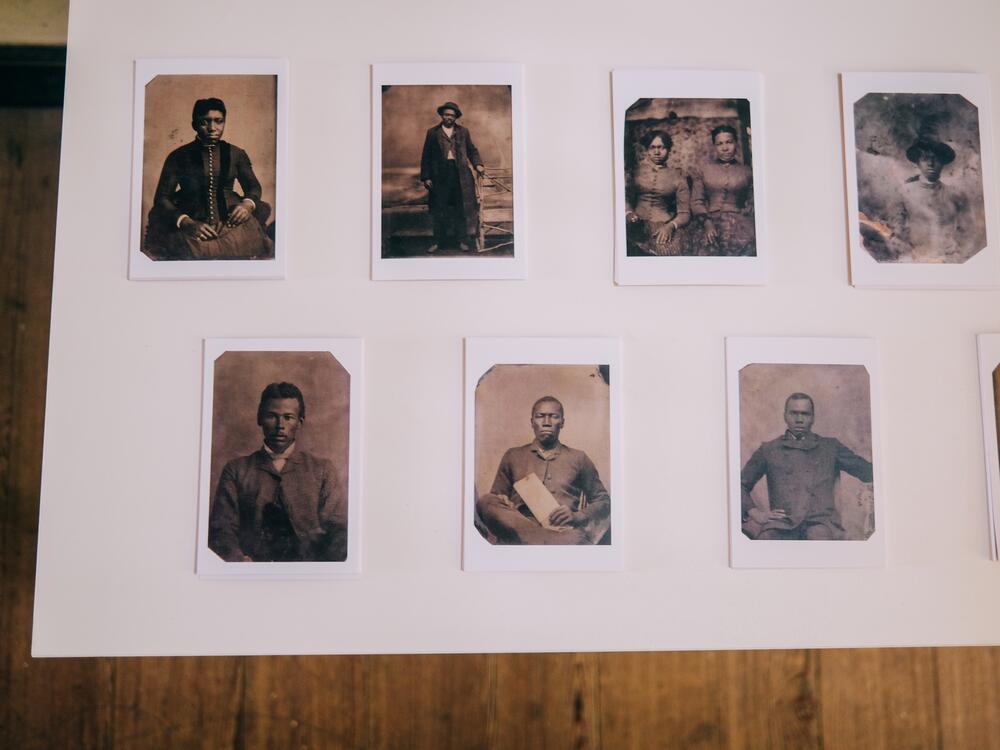 To begin their journey through the exhibit, visitors select a reproduction tintype showing formerly enslaved people whose names have been lost to time.