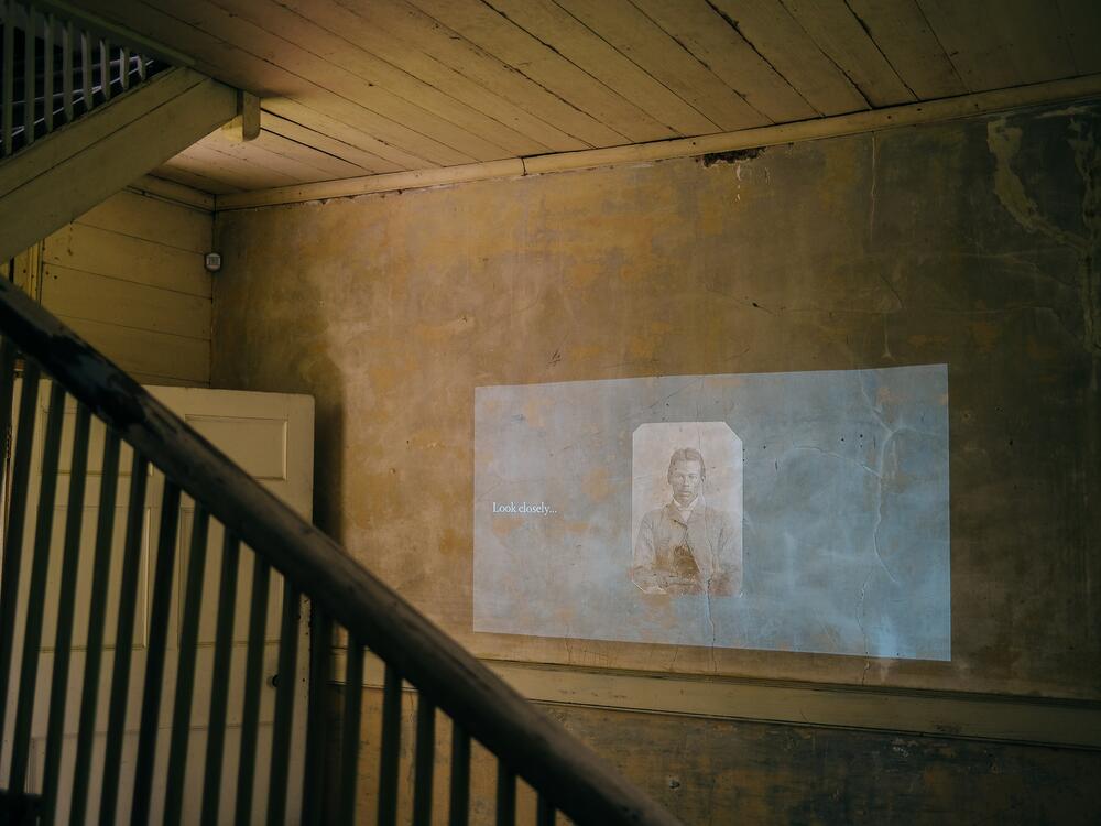 The installation occupies the first floor of the 1841 house with photos projected onto the wall prompting visitors to contemplate what is, and isn't, knowable from the images.
