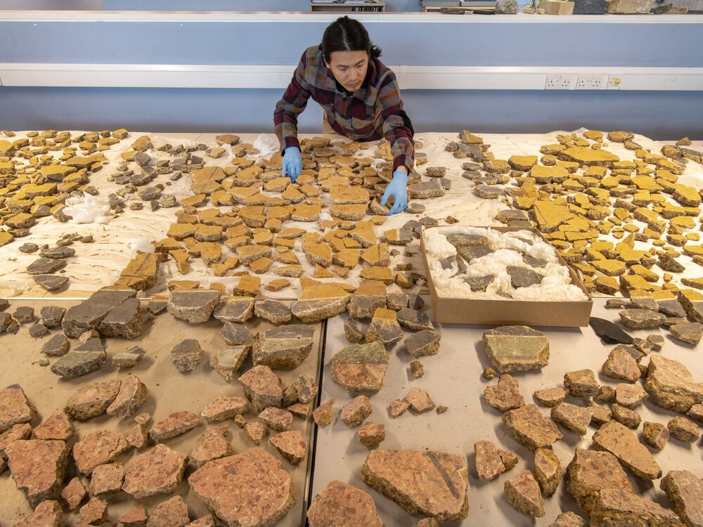 Museum of London Archaeology specialist Han Li lays out plaster fragments found in London from a Roman building that was demolished some time before A.D. 200.