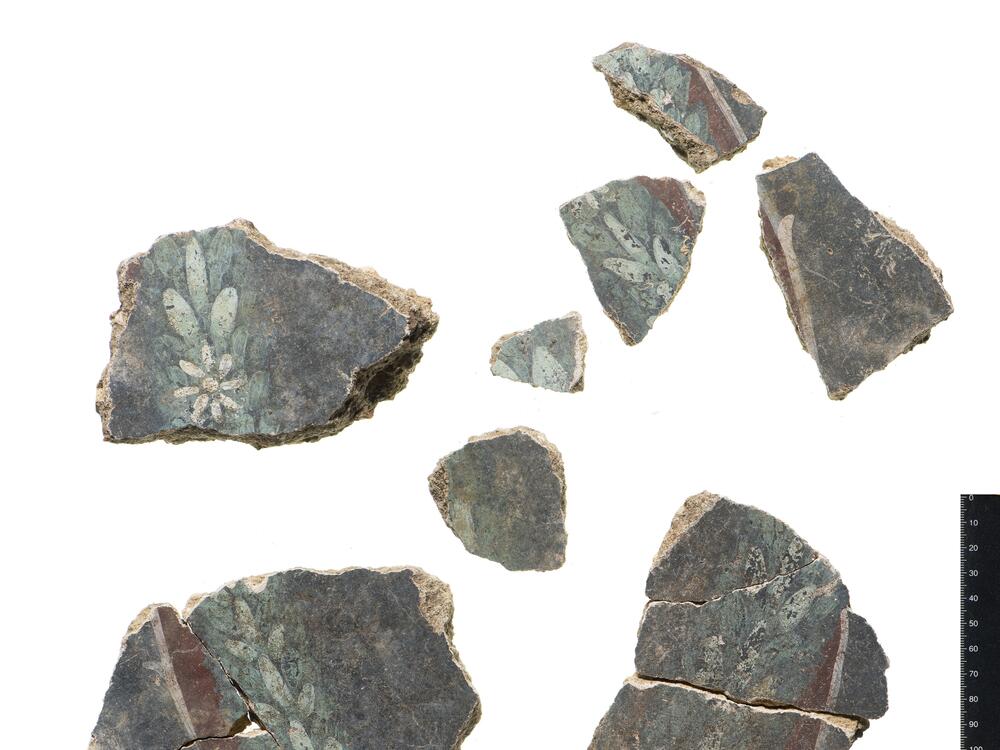 Sections of floral decoration are seen on the Liberty wall plaster. The recovered artworks depict bright yellow panel designs interspersed with black sections, exquisitely decorated with motifs of birds, fruit, flowers and lyres.