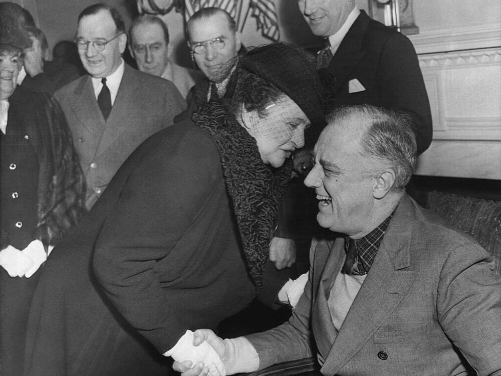 Frances Perkins is shown greeting President Franklin D. Roosevelt in 1943. Perkins was U.S. secretary of labor under Roosevelt from 1933 to 1945 and architect of the Social Security Act of 1935, which established federal support for elders, unemployed people, children and those who are blind.