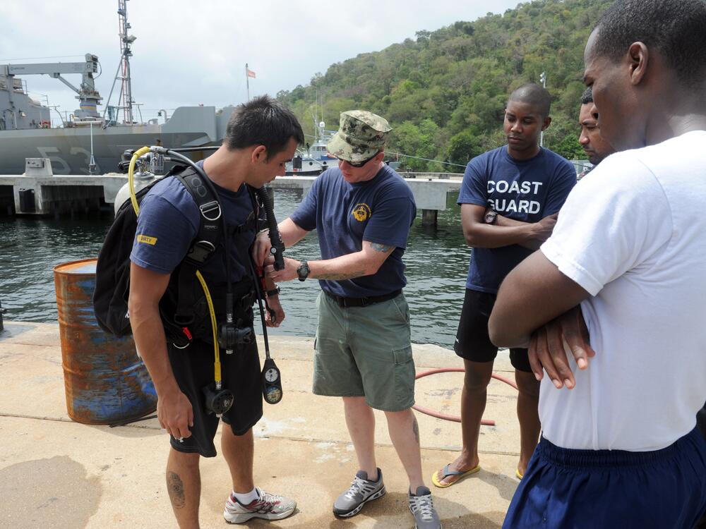 Navy Diver Matt Kelly (left) in Scuba gear on a training mission with divers from Trinidad and Tobago in 2012.<br>
