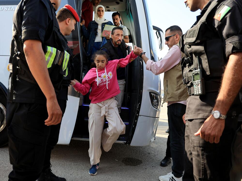 A child gets off a bus near the Jordanian border with other pediatric patients who have been evacuated from Gaza through Israel on June 11.