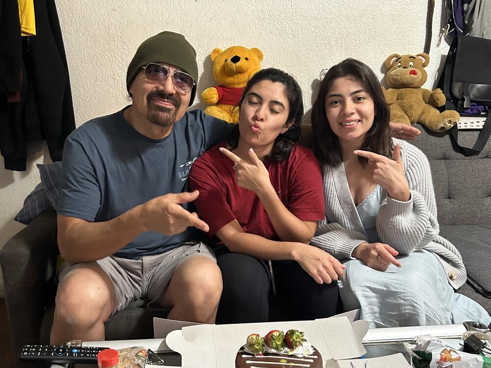 Francisco Urizar celebrates his 64th birthday with his daughters Nancy (center) and Francis (right). Since her father was taken into Immigrations and Customs Enforcement custody earlier in the week, Nancy has been frantically searching for clues about where, and why, he has been detained.