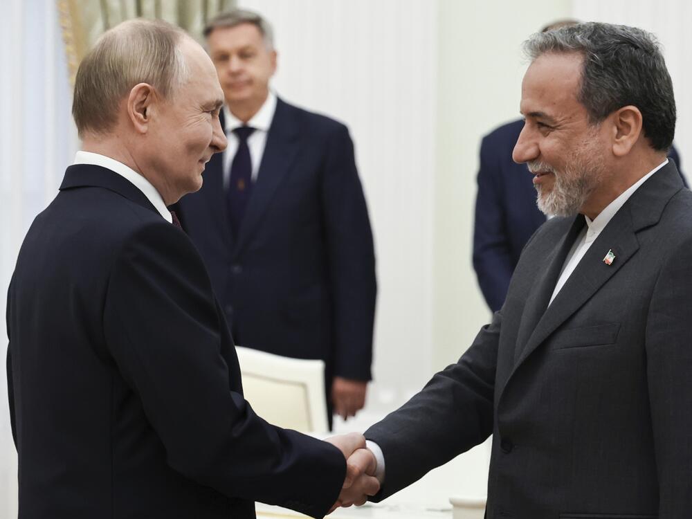 Russian President Vladimir Putin (left) greets Iranian Foreign Minister Abbas Araghchi prior to their talks at the Kremlin in Moscow, Monday.