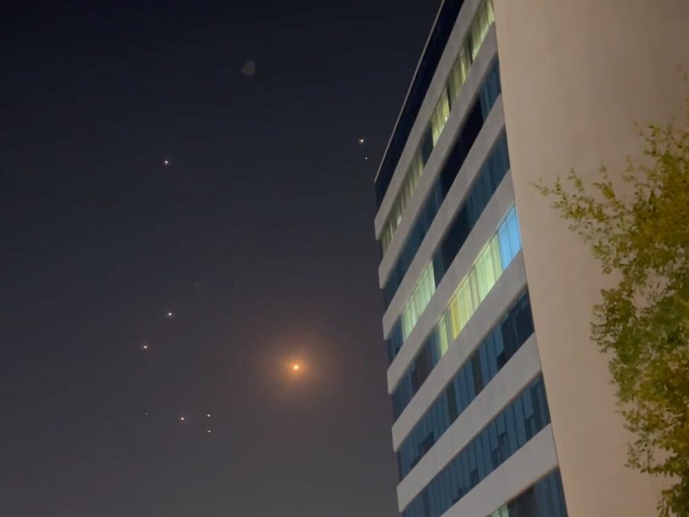In this screenshot from a video, missiles and air defense interceptors illuminate the night sky over Doha after Iran launched an attack on U.S. forces at Al Udeid Air Base in Qatar on Monday.