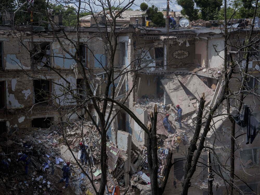 Rescue workers clear the rubble of a residential house destroyed by a Russian strike in Kyiv, Ukraine, on Monday, June 23, 2025.