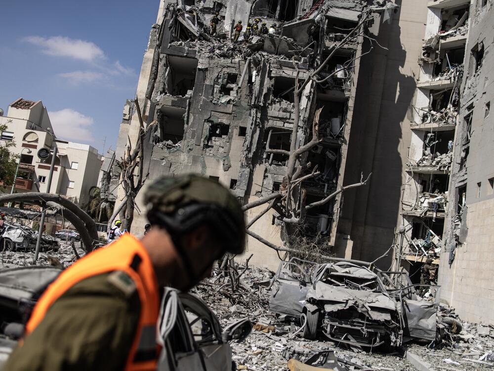 Israeli emergency services and security officers search for casualties in the rubble of a building hit by an Iranian missile in Beersheba in southern Israel on June 24, 2025.