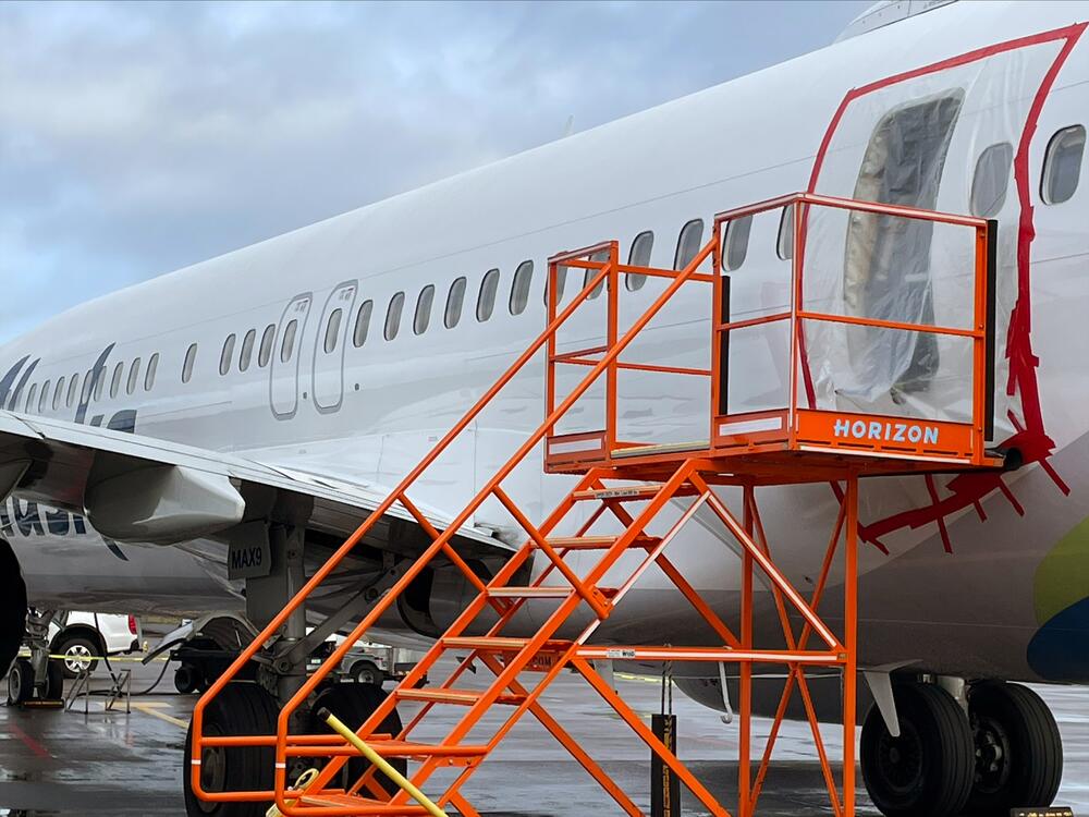 In this National Transportation Safety Board handout photo, plastic covers the exterior of the fuselage plug area of Alaska Airlines Flight 1282, a Boeing 737 Max, on January 7, 2024 in Portland, Ore. A door-sized section near the rear of the plane blew off 10 minutes after takeoff on January 5 on its way to Ontario, Calif.