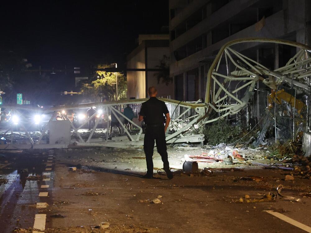 A crane sits on the street after crashing down into the building housing the Tampa Bay Times offices after the arrival of Hurricane Milton in St. Petersburg, Florida. Milton, which comes just after the recent catastrophic Hurricane Helene,  landed into Florida's Gulf Coast late Wednesday evening as a Category 3 storm causing extensive flooding and damage.