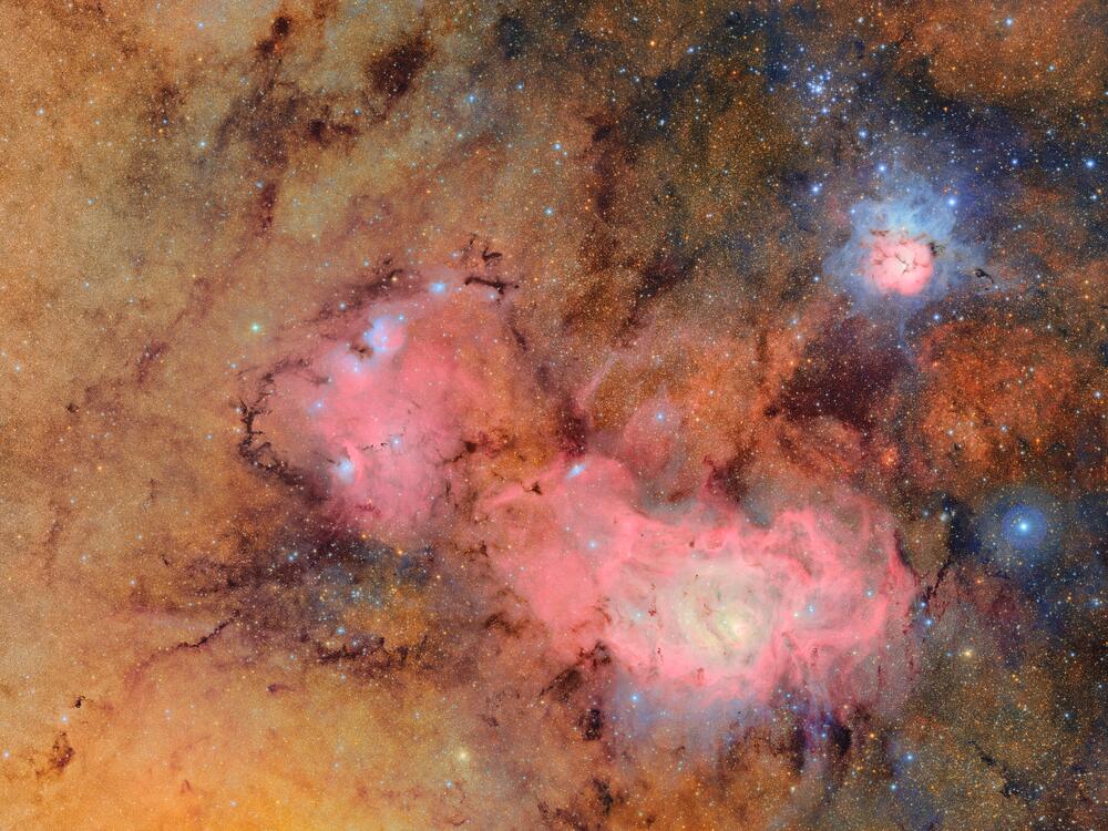 This image combines 678 separate images taken by NSF-DOE Vera C. Rubin Observatory in just over seven hours of observing time. Combining many images in this way clearly reveals otherwise faint or invisible details, such as the clouds of gas and dust that comprise the Trifid nebula (top right) and the Lagoon nebula, which are several thousand light-years away from Earth.