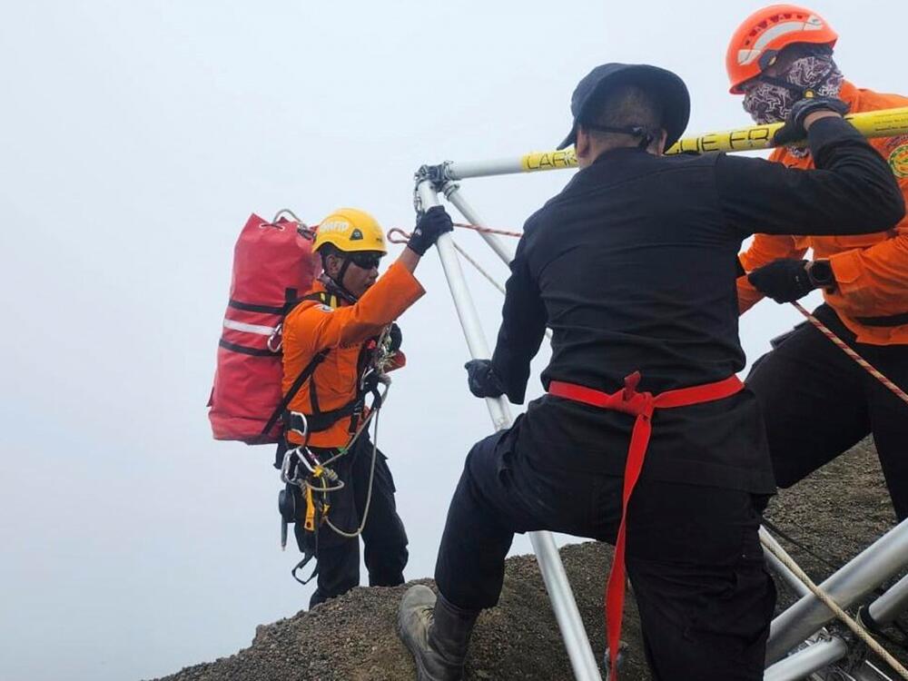 In this undated photo released by the Indonesian National Search and Rescue Agency on Tuesday, June 24, 2025, a rescuer climbs down the ridge of Mount Rinjani during the evacuation operation for Juliana Marins, a Brazilian tourist who fell while hiking near the volcano's summit, in Lombok, Indonesia.