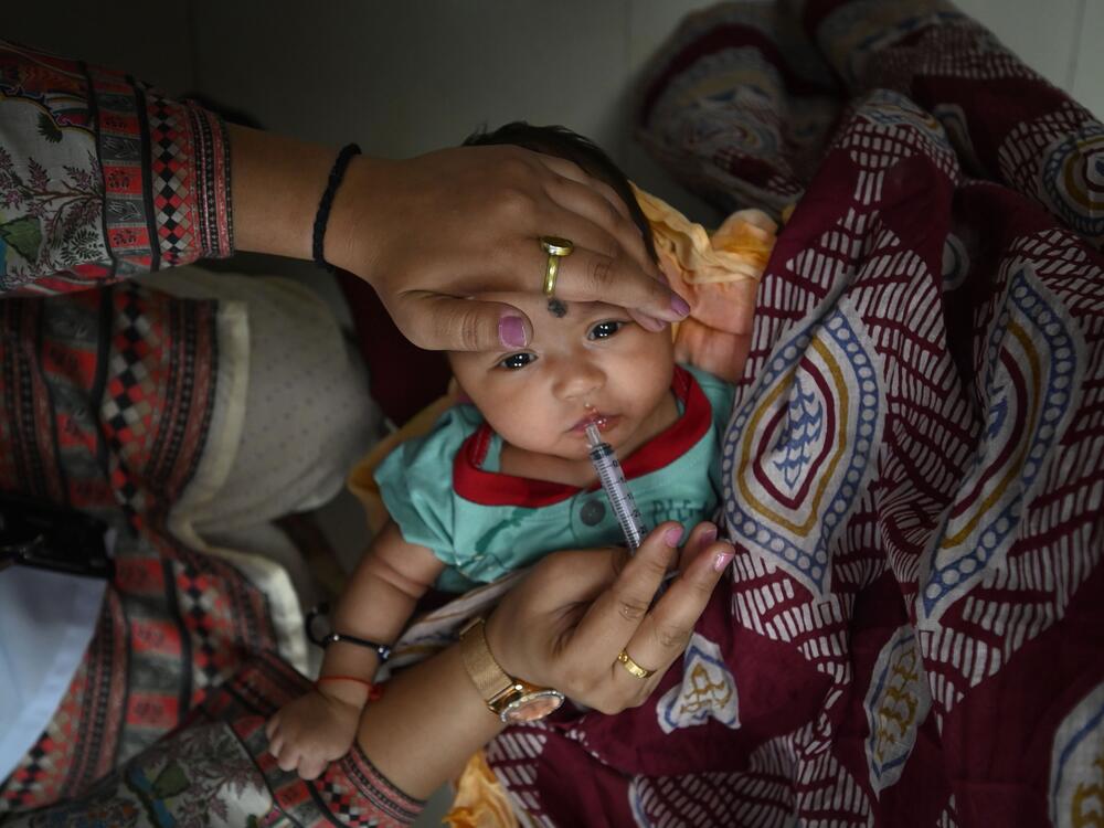 A child gets an oral vaccine in New Delhi, India, on June 17. India has made notable progress in improving access to childhood vaccinations.