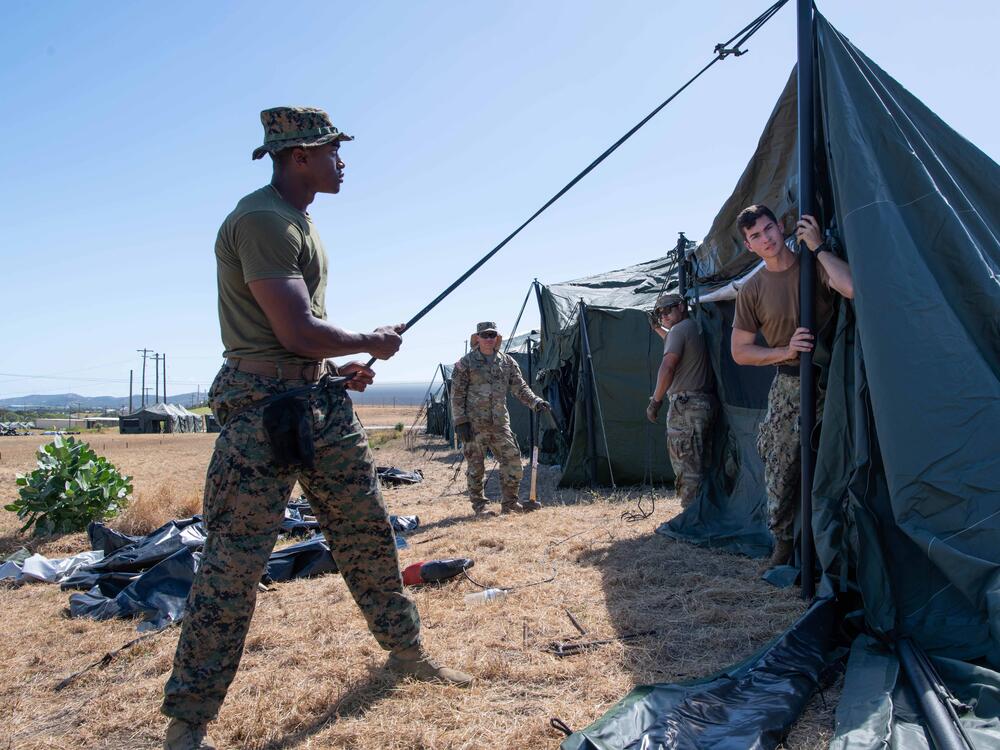 U.S. service members set up tents to house migrants in February 2025, at Naval Station Guantanamo Bay. Several hundred tents were erected; so far none have been used.