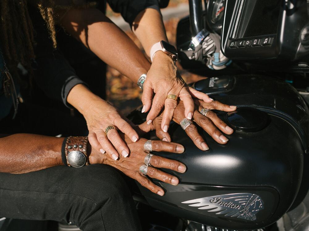 Cathy places her hands on Gevin's in front of their home in Van Nuys, Calif.
