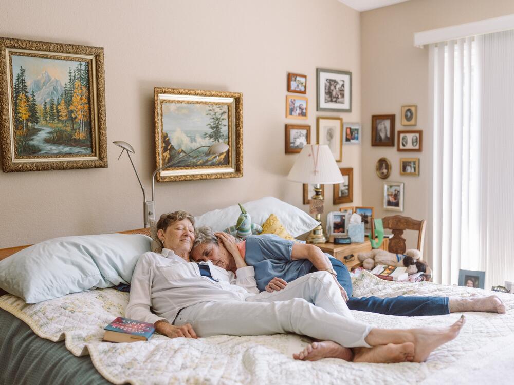 Dinah Davis (left) and Sally Jones embrace each other in their bedroom in their home in Aptos, Calif.